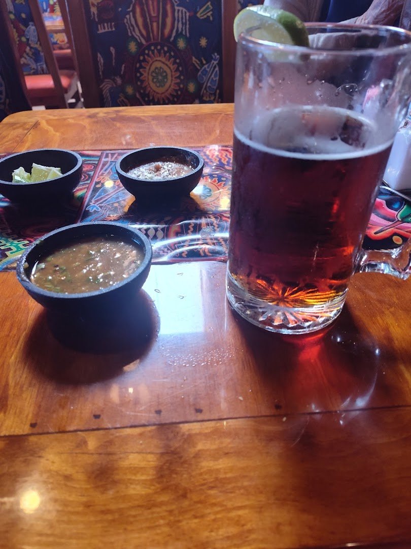 Plates of fajitas and soup on a table.
